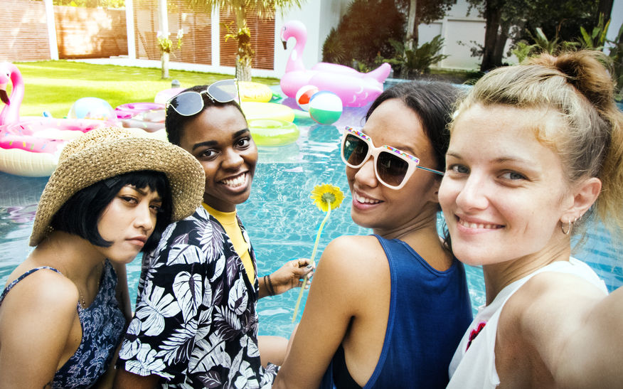 Friends taking a selfie at the pool